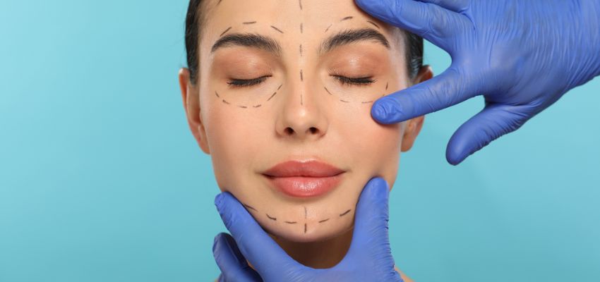 A cosmetic surgeon prepares a woman before undergoing facelift surgery.