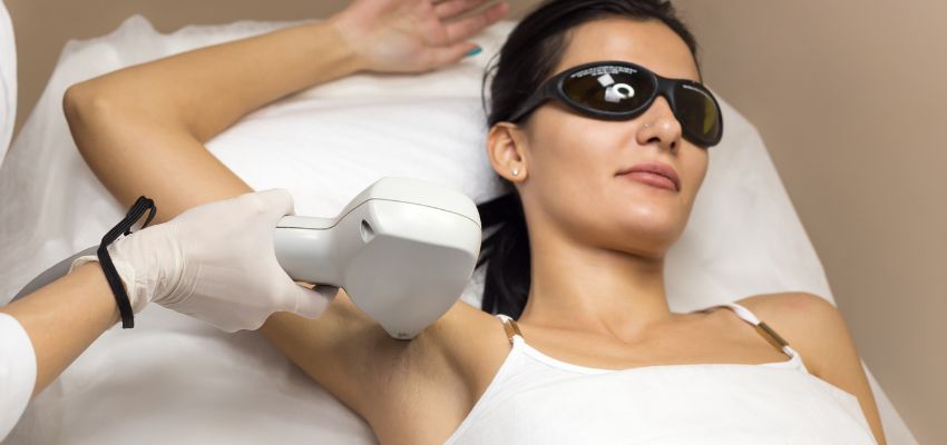 The woman undergoes laser hair removal to have flawless armpits.