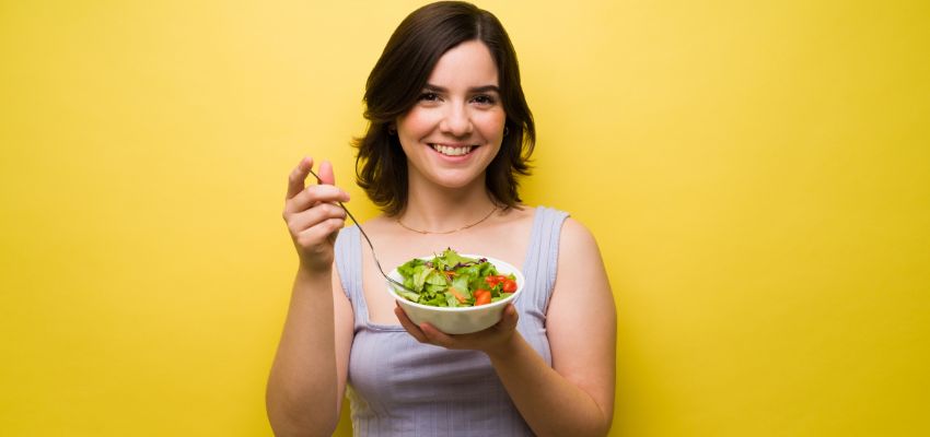 The woman eats foods rich in fiber, potassium, and antioxidants, which help the roots stay healthy and strong.