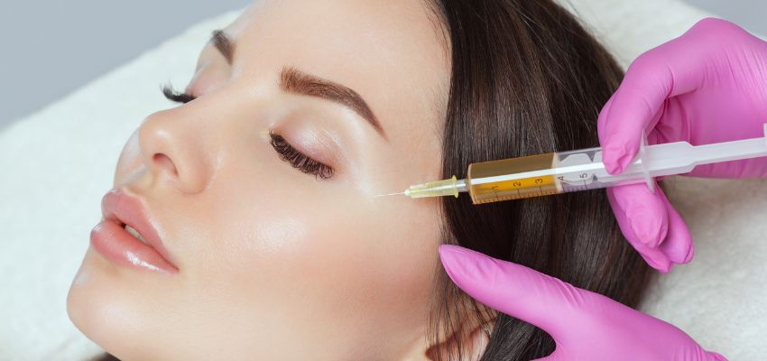 Aesthetic procedure with platelet rich fibrin injections on a woman’s face.