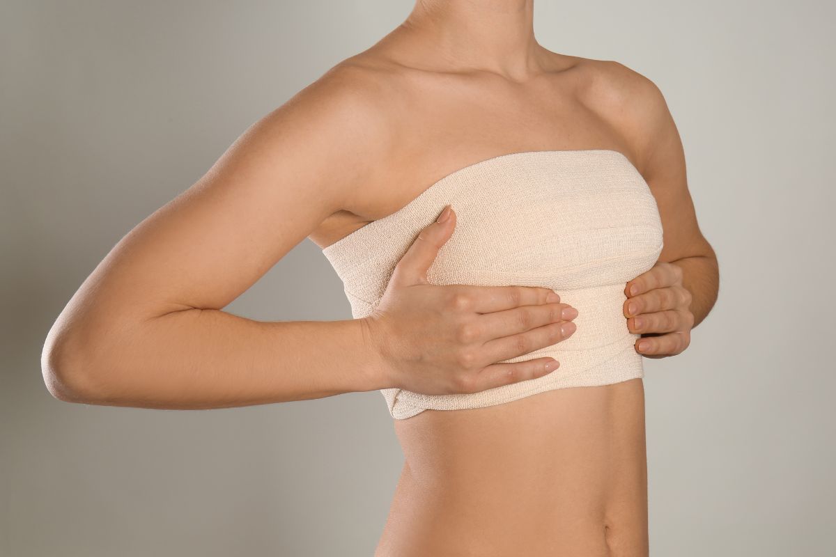 The woman checks her breasts to see if they get bigger.